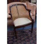 A MAHOGANY AND CANED BERGERE CHAIR