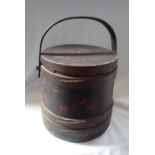 A WOODEN LIDDED BUCKET, PAINTED WITH CHERRIES ON A BLACK GROUND