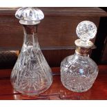 TWO CUT GLASS DECANTERS WITH SILVER COLLARS