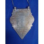 A WHITE METAL PENDANT WITH ENGRAVED FISH AND INSCRIPTION