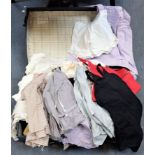A SUITCASE CONTAINING A COLLECTION OF CHILDREN'S CLOTHES, AND OTHERS