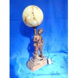 A SPELTER FIGURAL LAMP WITH A GLASS GLOBE SHADE