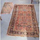 A RED GROUND RUG WITH GEOMETRIC DECORATION
