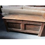 A SMALL 17TH CENTURY OAK COFFER, PANELLED FRONT