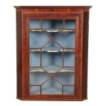 A GEORGE III MAHOGANY HANGING CORNER CABINET