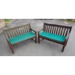 A PAIR OF WEATHERED TEAK GARDEN BENCHES, WITH CONTOURED BACK SPLATS