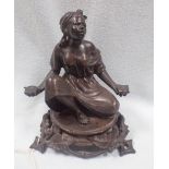 A BRONZE SEATED FIGURE OF A LADY
