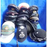 A COLLECTION OF UNIFORM CAPS AND HATS