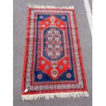 A BLUE GROUND RUG OF TRADITIONAL DESIGN