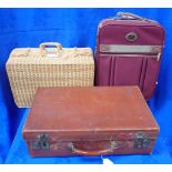 A VINTAGE LEATHER SUITCASE