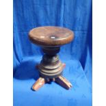 AN OLD WOODEN AND IRON CAPSTAN