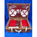 A WICKER PICNIC BASKET