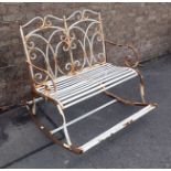 A METAL FRAMED ROCKING GARDEN SEAT FOR TWO