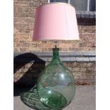 A LARGE GLASS CARBOY, FITTED AS A LAMP