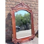 A CARTOUCHE SHAPED WALL MIRROR