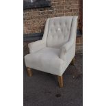 A WHITE UPHOLSTERED OKA CHAIR