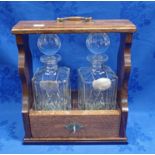 AN OAK CASED TANTALUS WITH TWO SILVER DECANTER LABELS