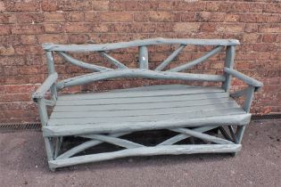 A RUSTIC PAINTED WOOD GARDEN BENCH