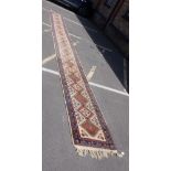 A LONG CREAM-GROUND TABRIZ RUNNER