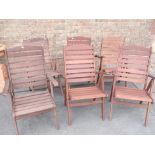 A SET OF SIX TEAK GARDEN ARMCHAIRS