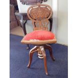 A LATE VICTORIAN ADJUSTABLE MUSIC STOOL