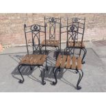 A SET OF FOUR WROUGHT METAL GARDEN CHAIRS