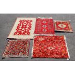 FIVE RED GROUND RUGS