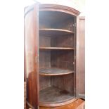A MAHOGANY BOW-FRONTED HANGING CORNER CUPBOARD