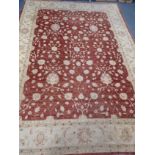 A LARGE RED GROUND PERSIAN DESIGN RUG