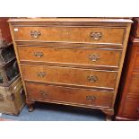 A FIGURED WALNUT AND MAHOGANY CHEST OF DRAWERS