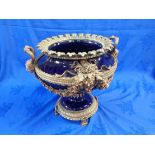 A LARGE LOUIS XV STYLE GLAZED CERAMIC AND CAST BRASS URN