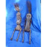 TWO TRIBAL CARVED AND JOINTED WOODEN FIGURES