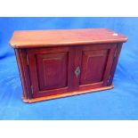 A SMALL WALL HANGING MAHOGANY CUPBOARD