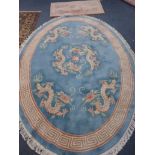 A CHINESE BLUE GROUND OVAL RUG