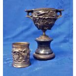 A BRONZE DECORATED URN ON STAND