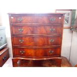 A REPRODUCTION FIGURED MAHOGANY SERPENTINE CHEST OF DRAWERS