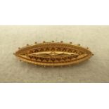AN UNMARKED GOLD ETRUSCAN REVIVAL BROOCH