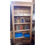 A TALL STRIPPED PINE OPEN BOOKCASE