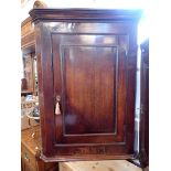 A GEORGE III OAK CORNER CUPBOARD