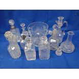 A LARGE CUT GLASS ICE BUCKET AND A COLLECTION OF DECANTERS
