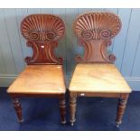 A PAIR OF EARLY VICTORIAN MAHOGANY SCALLOP-BACK HALL CHAIRS