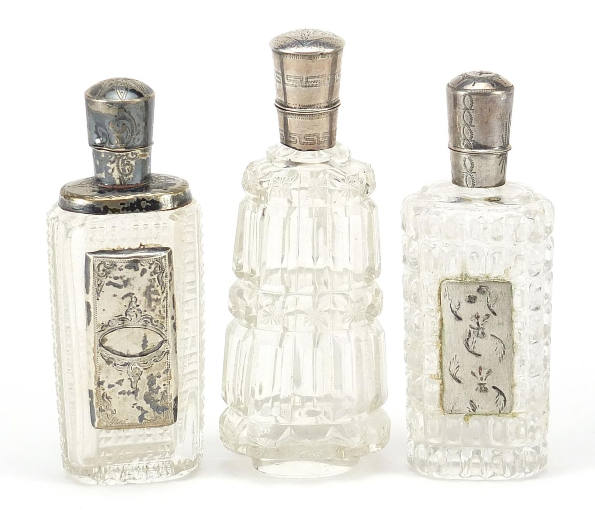 Three Dutch silver mounted cut glass scent bottles, the largest 9.5cm high