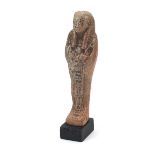 Egyptian style ushabti raised on a wooden base, overall 19cm high