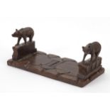 Black Forest extending book slide carved with two bears, 27.5cm wide when closed Overall in