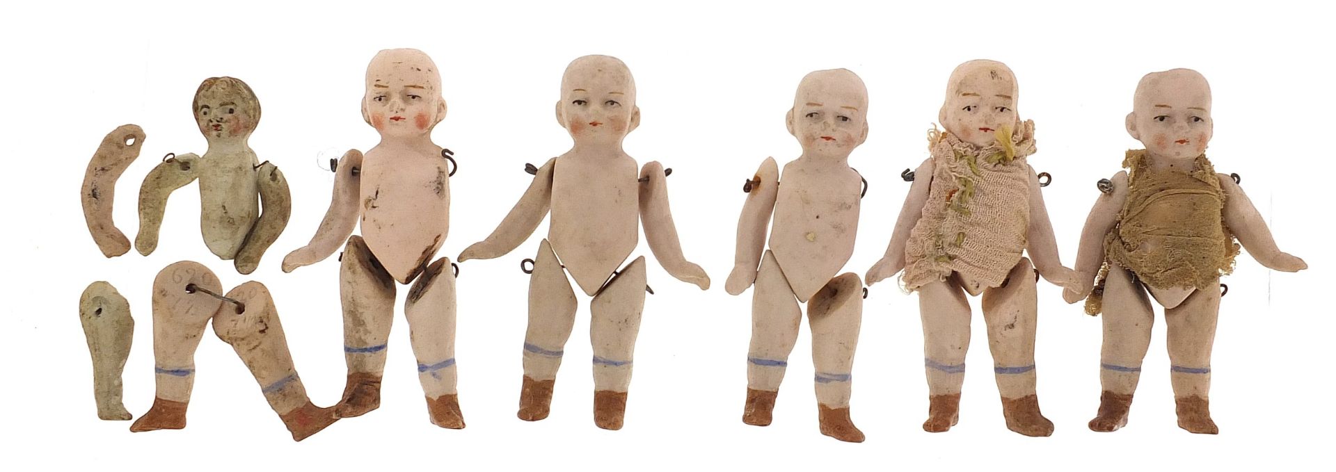 Six miniature German bisque dolls with jointed limbs, each 7cm high