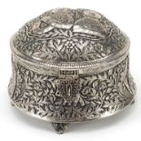 Indian white metal box and cover decorated with figures amongst flowers, 17cm high x 21cm in