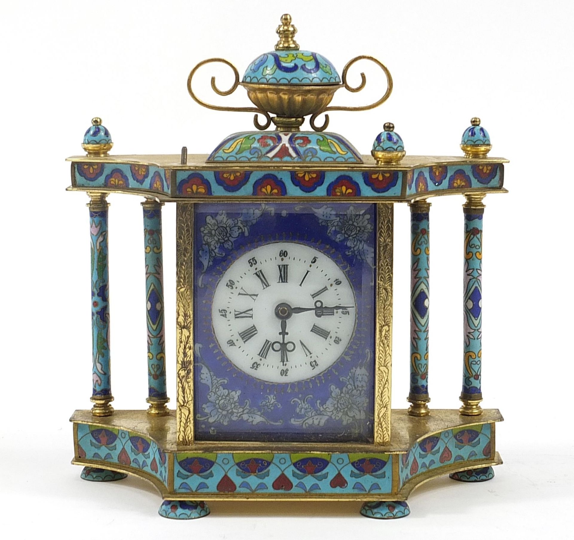 Champleve enamel and brass mantle clock with urn finial and circular dial having Roman and Arabic