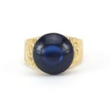 Antique unmarked gold cabochon blue stone ring, the band with engraved decoration, (tests as 15ct+