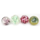 Four colourful art glass paperweights including Langham, the largest 9.5cm high