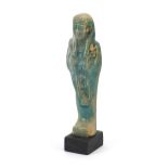 Egyptian style ushabti raised on a wooden base, overall 18cm high